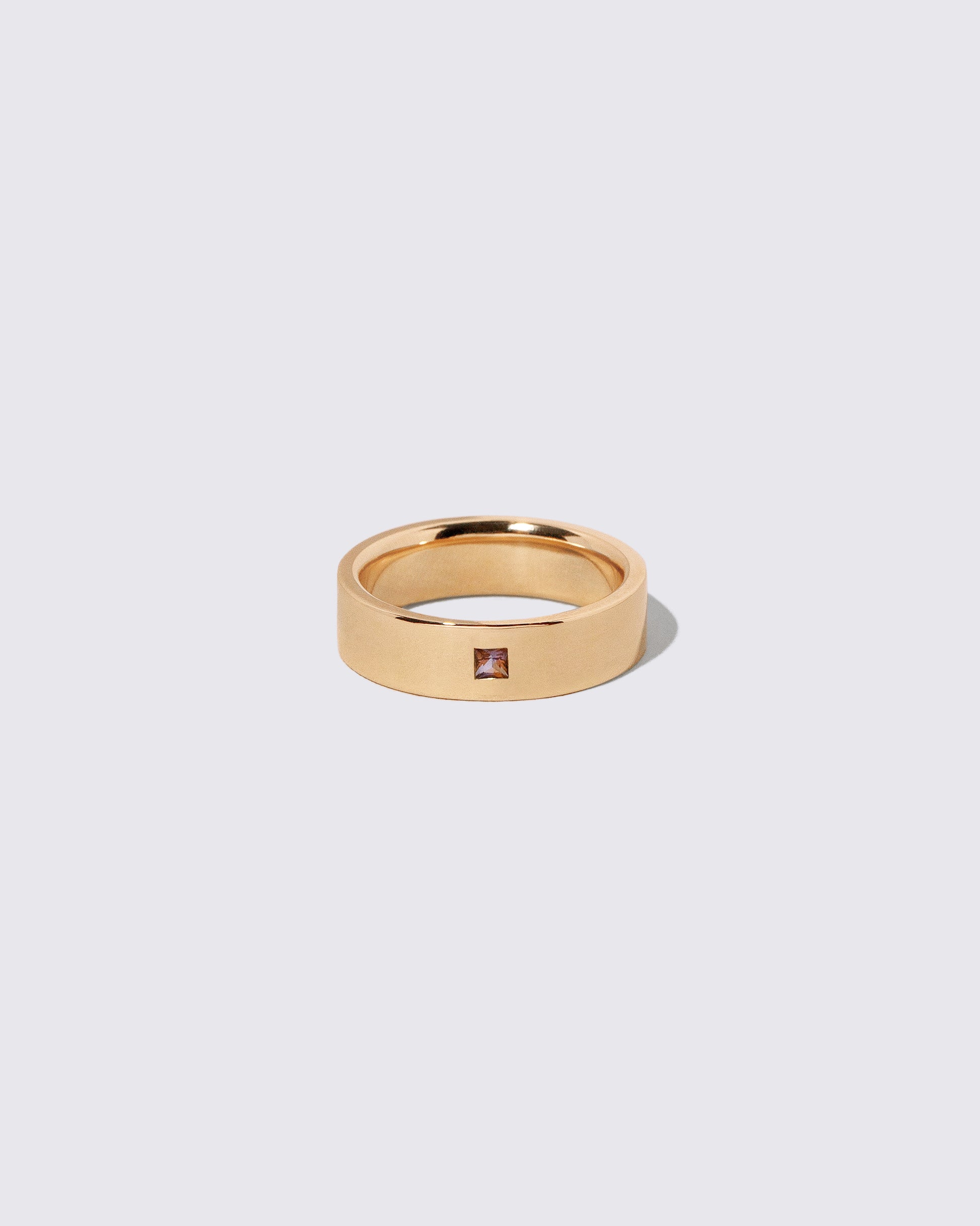 Gold Sri Lankan Bicolor Sapphire 6mm Square Cut Piet Band on light color background.