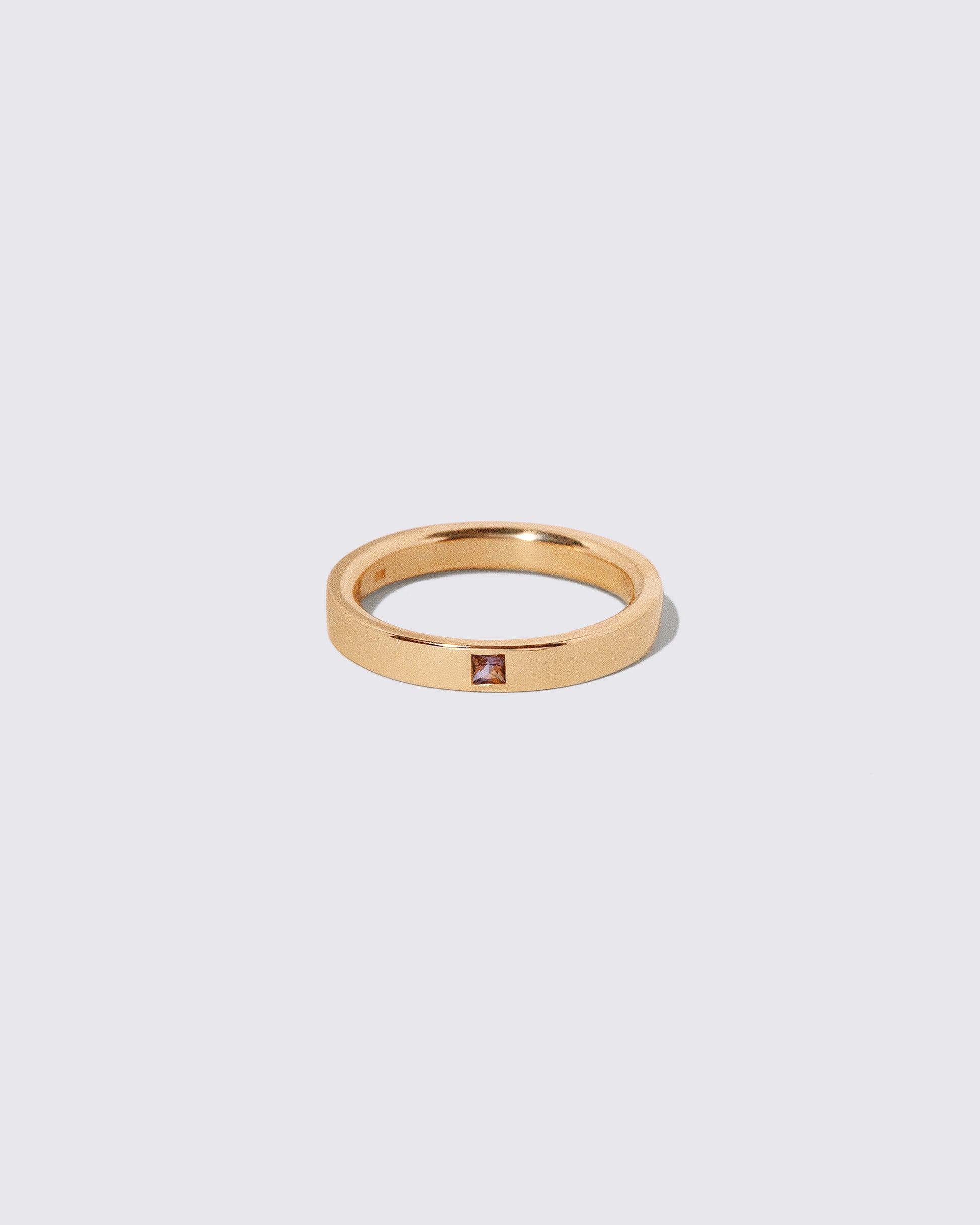 Gold Sri Lankan Bicolor Sapphire 3mm Square Cut Piet Band on light color background.