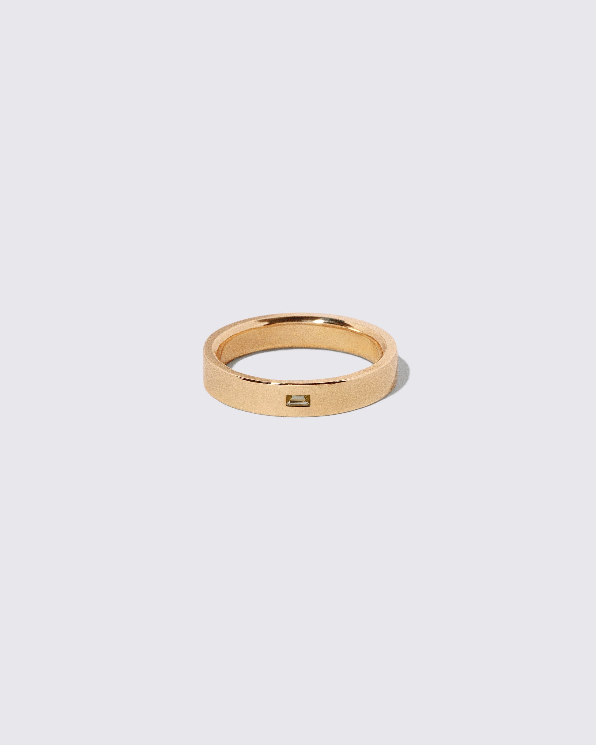 Gold Yellow Beryl East West 4mm Baguette-Set Piet Band on light color background.