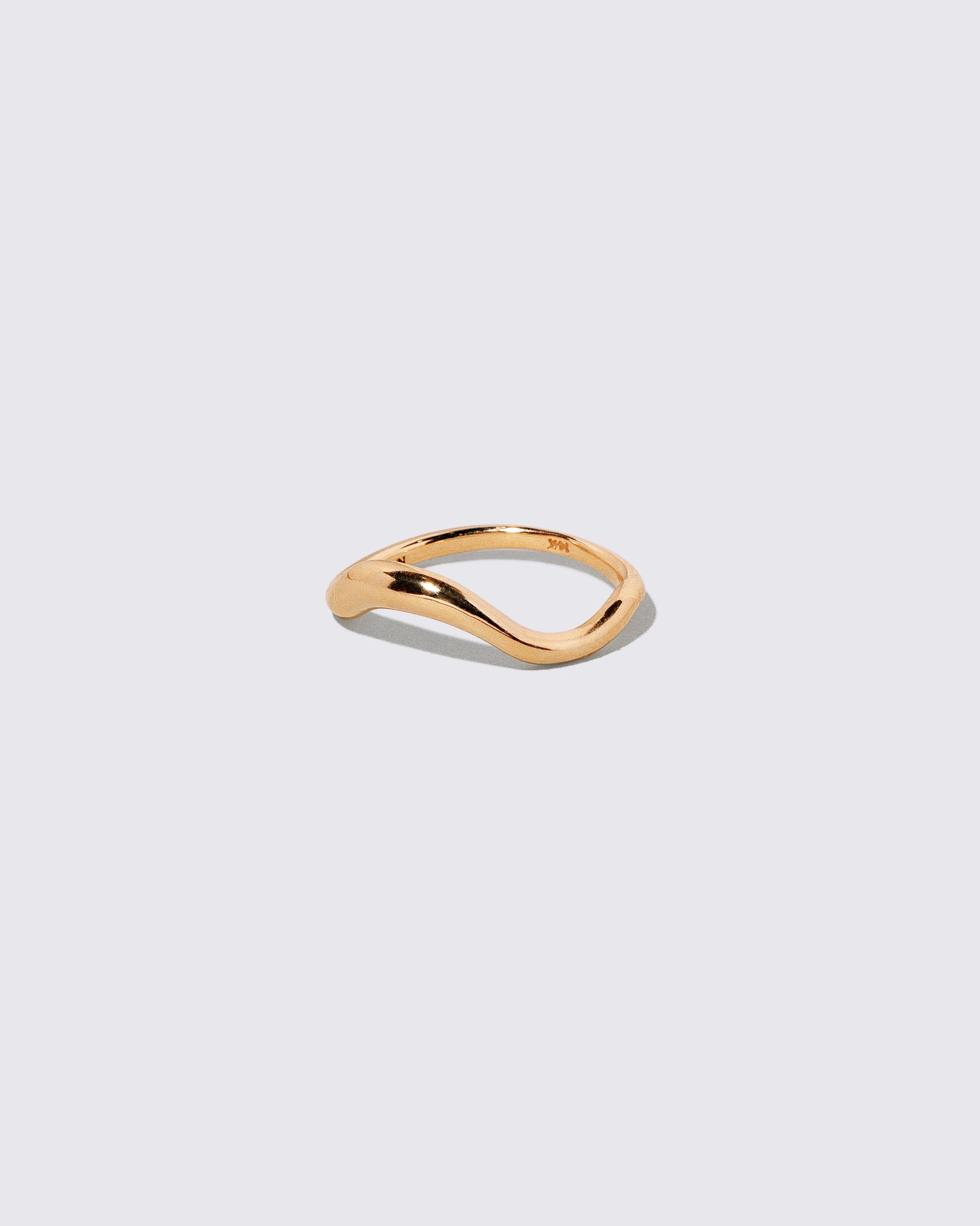 View from the side of the Gold Precise Band on light color background.