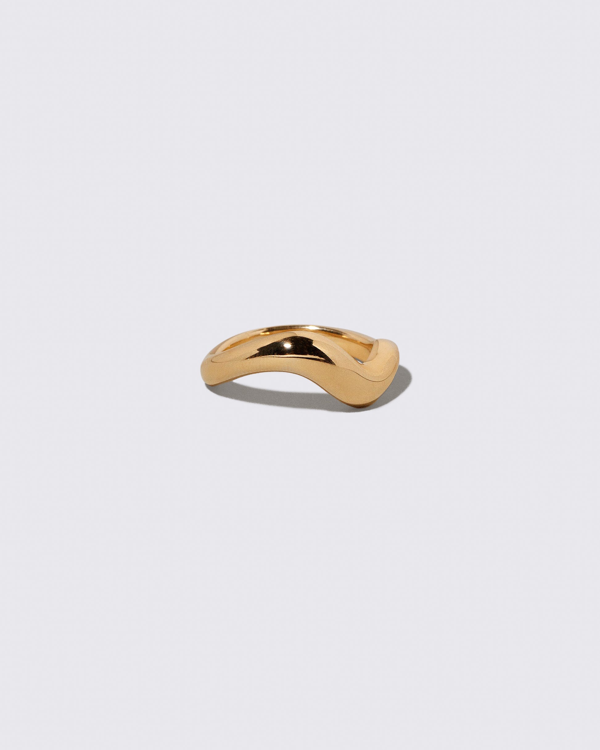 View from the side of the Gold Unbroken Band on light color background.