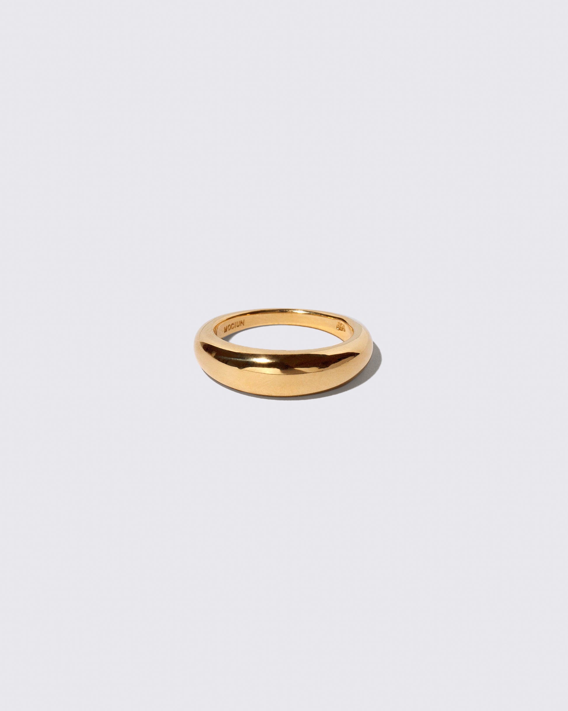 Gold 5.5mm Venus Band on light color background.