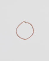 Pink Peony Lavender Seed Pearl Bracelet on light color background.