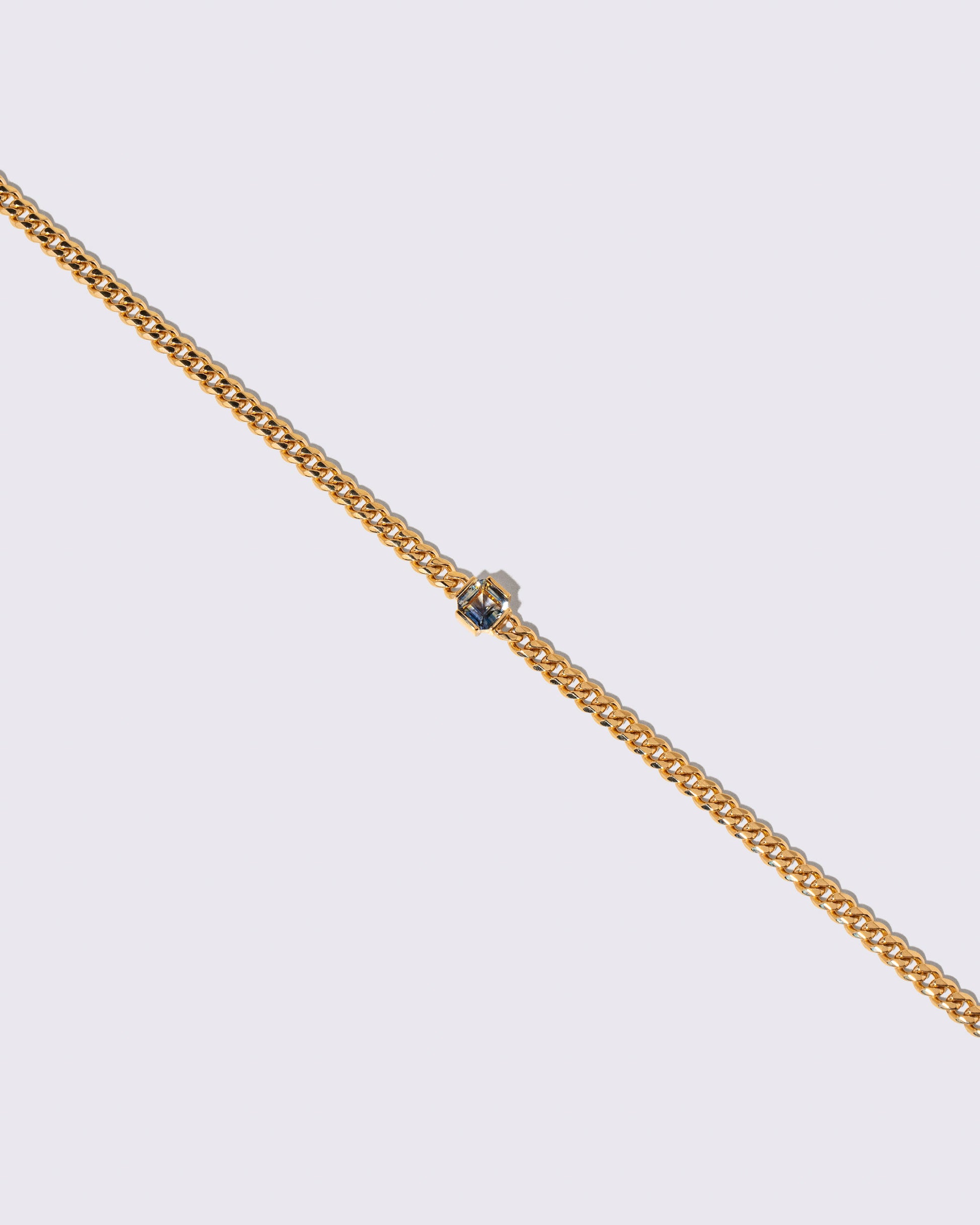 Closeup details of the Bicolor Sapphire Fold Bracelet on light color background.