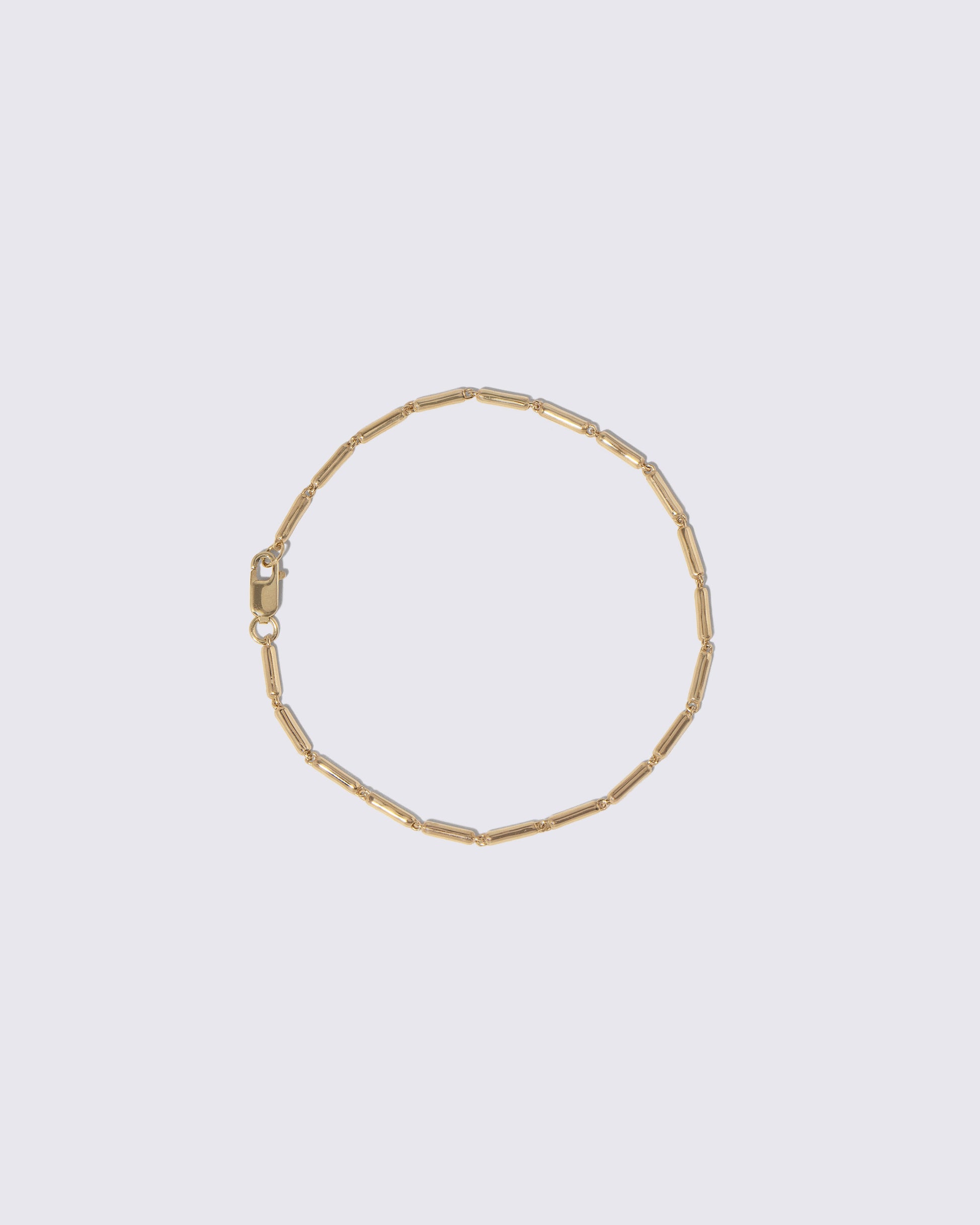 Gold Butter Chain Bracelet on light color background.