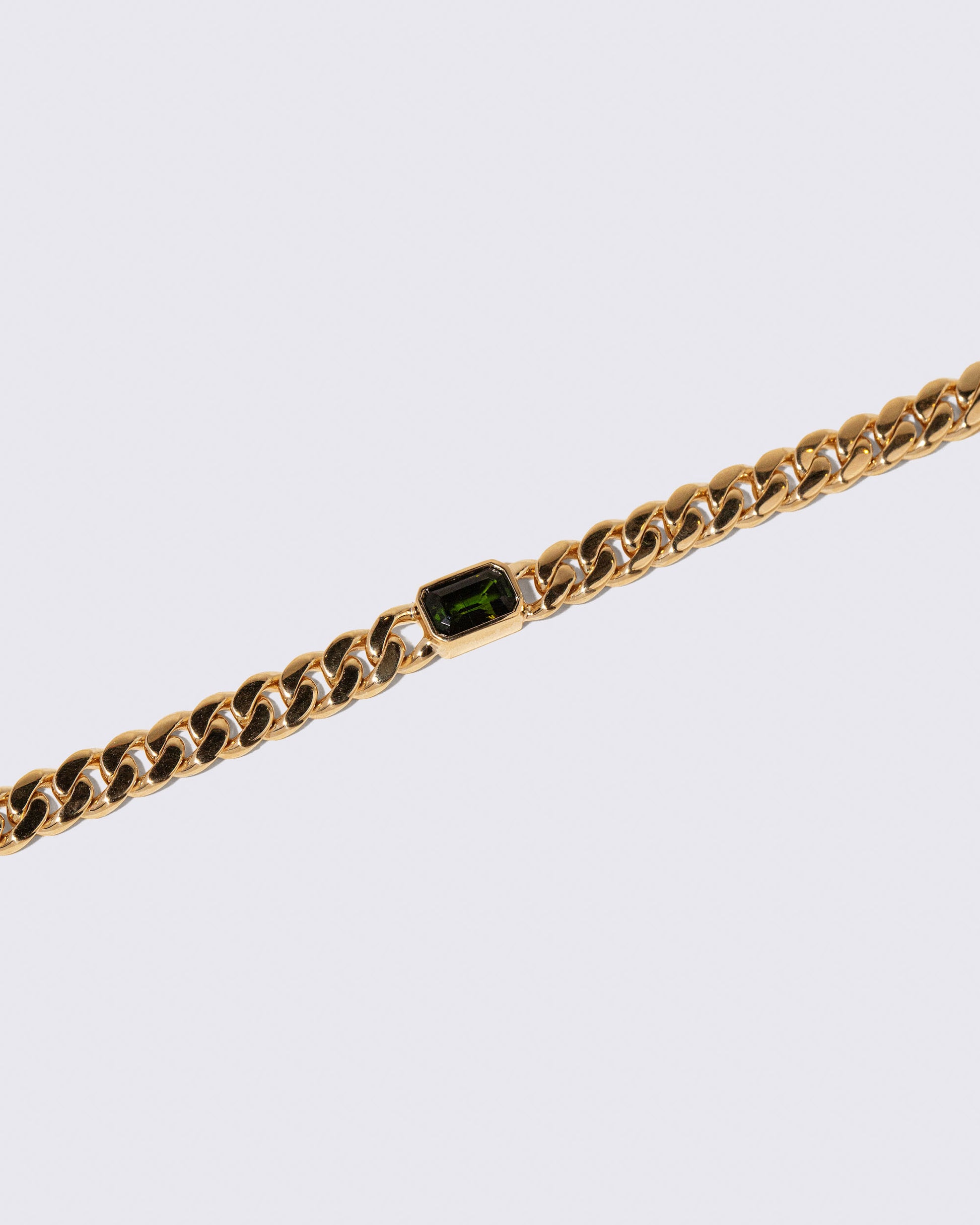 Closeup details of the Identity Chain Green Tourmaline Bracelet 001 on light color background.