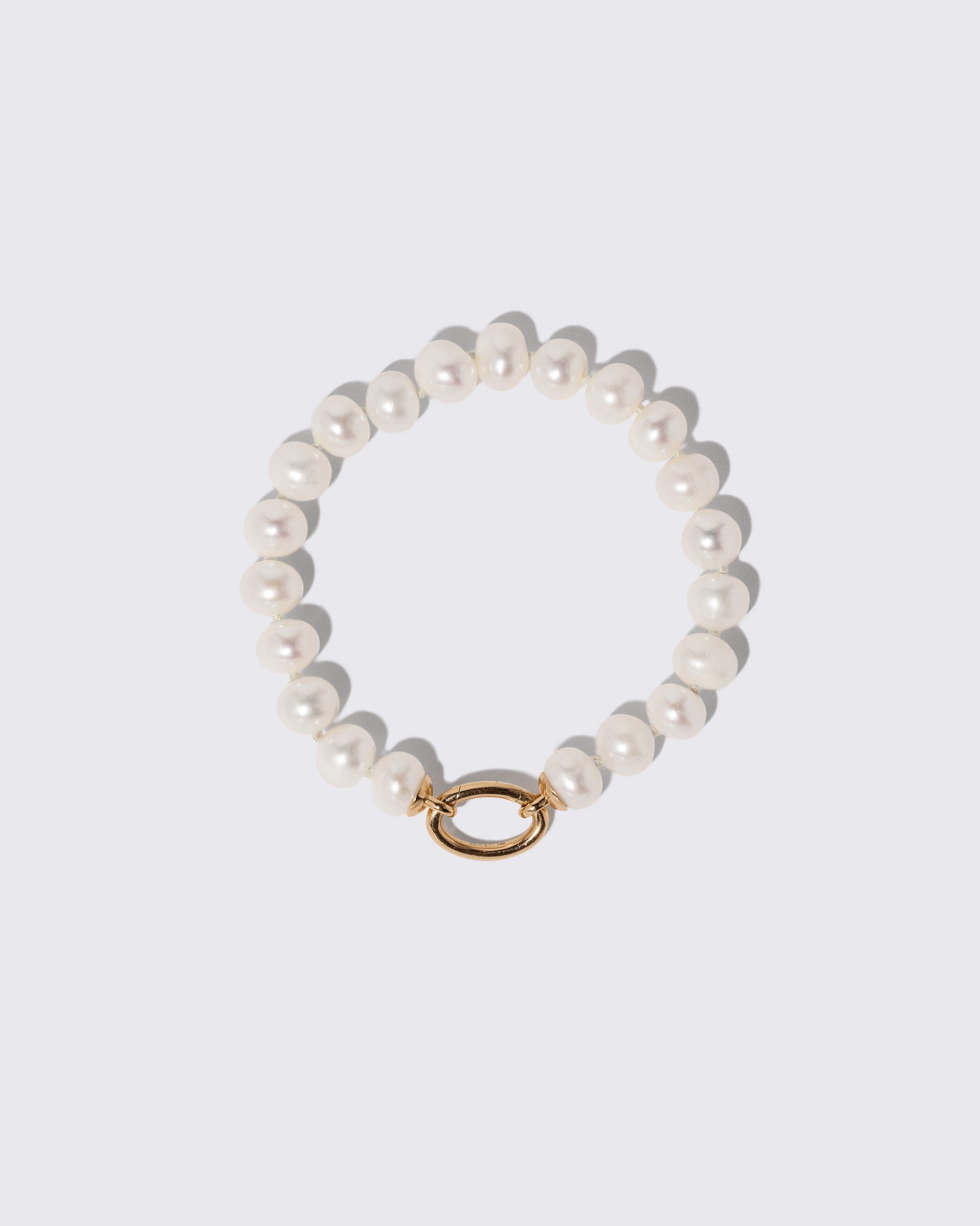 Gold Pearl Openable Link Bracelet on light color background.