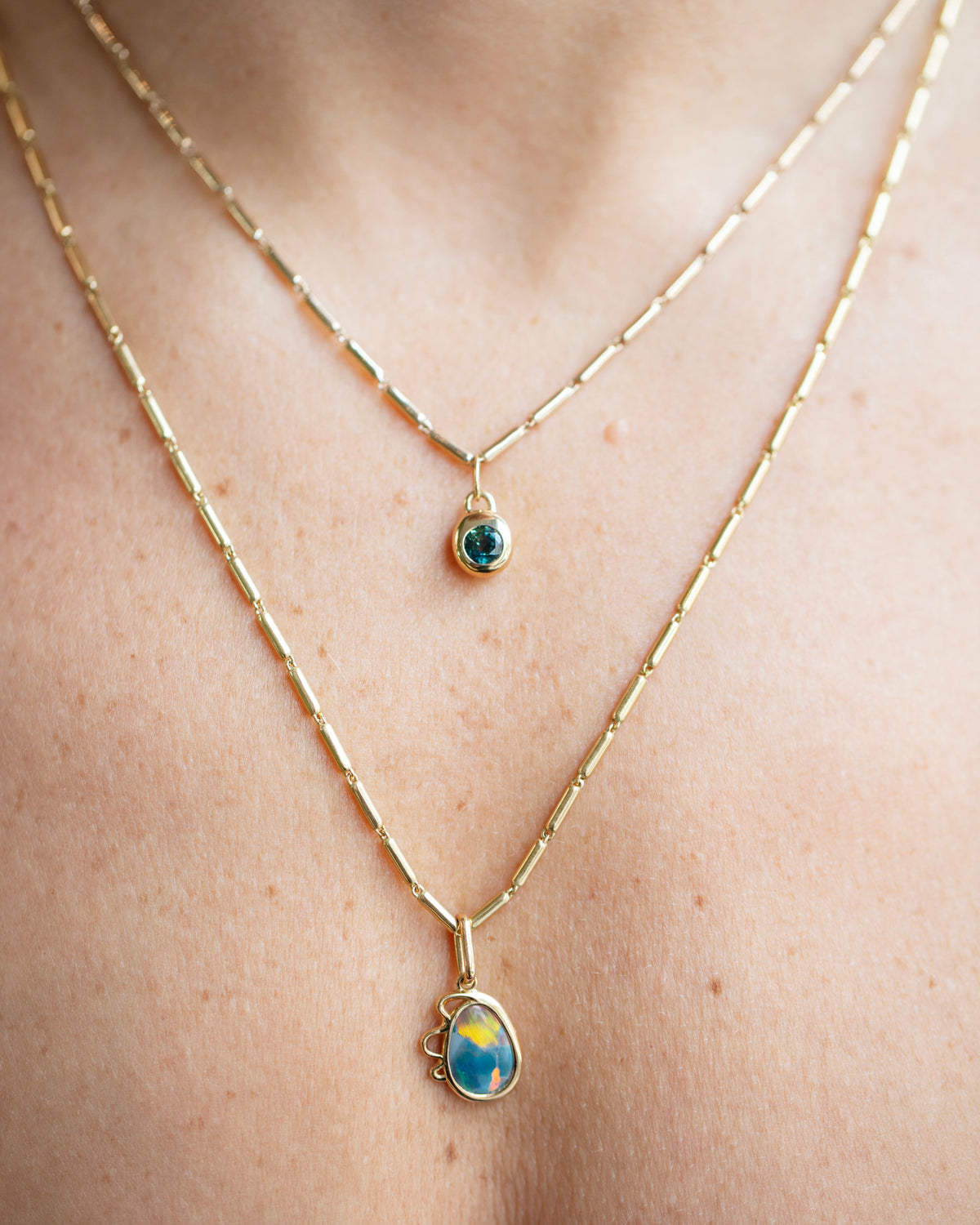 Gold Butter Chain Necklace, Harmony Pendant and Bicolor Sapphire Birthstone Level Charm on model.