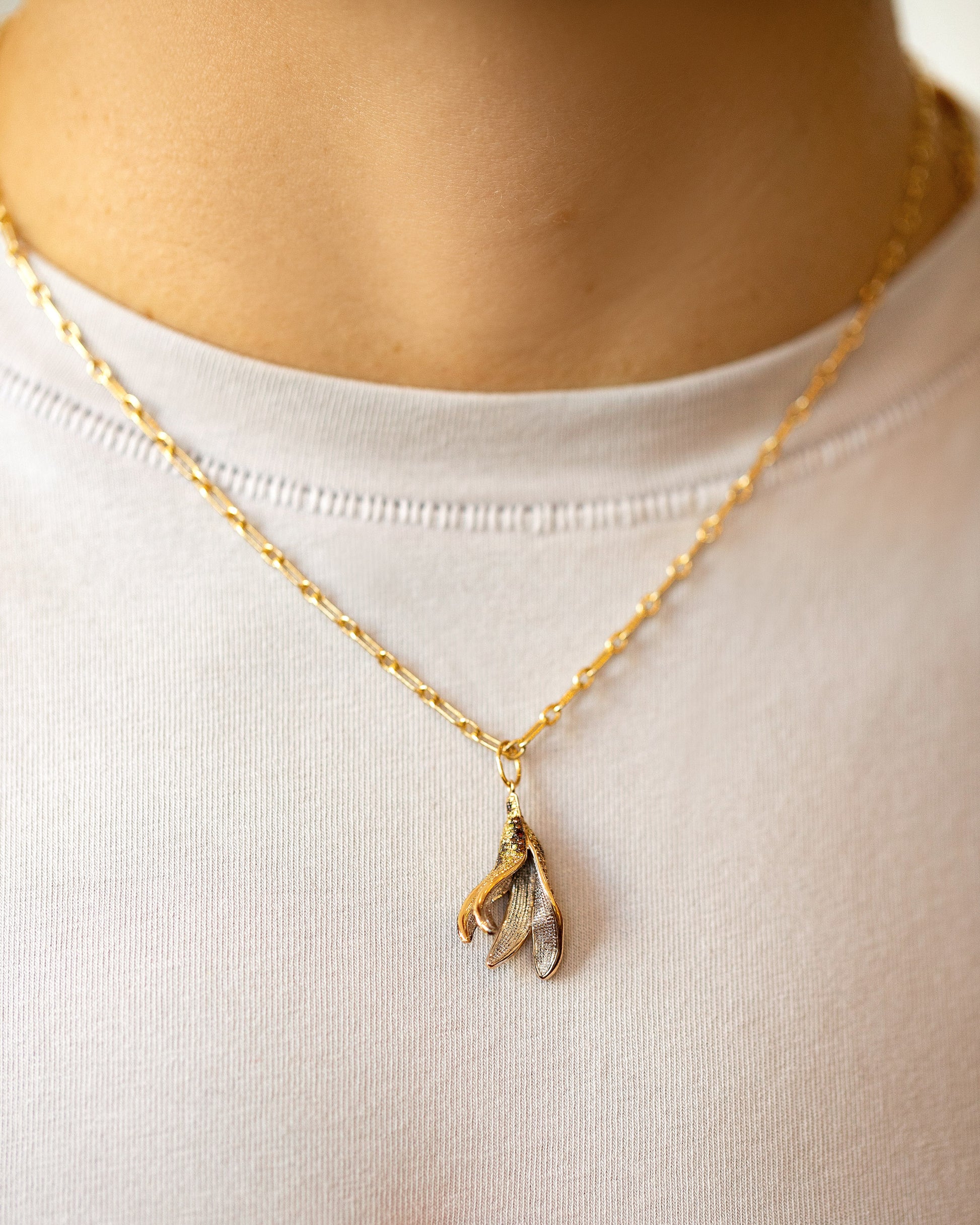 Bruised Banana Peel Charm and Hot Dog Chain Necklace on model.