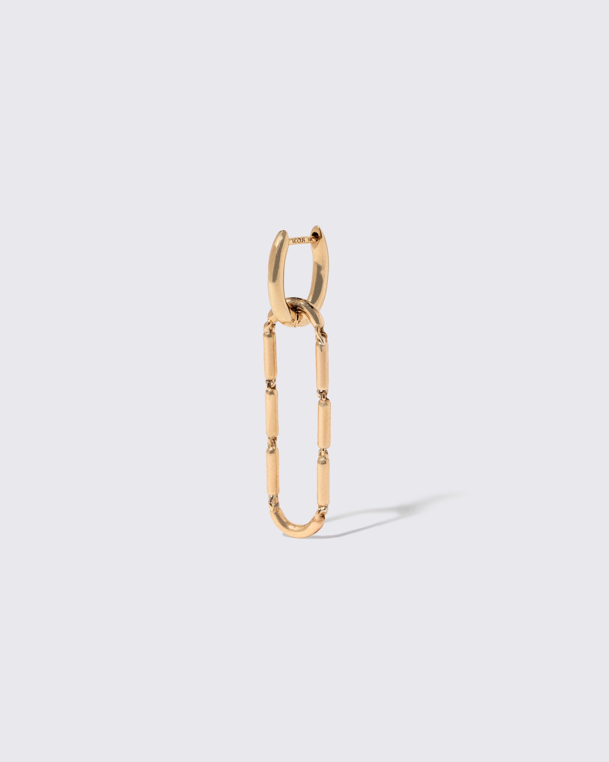 Closeup details of the Styling Huggie Hoop Earring Single and Butter Chain Styling Link on light color background. Earring sold separately.