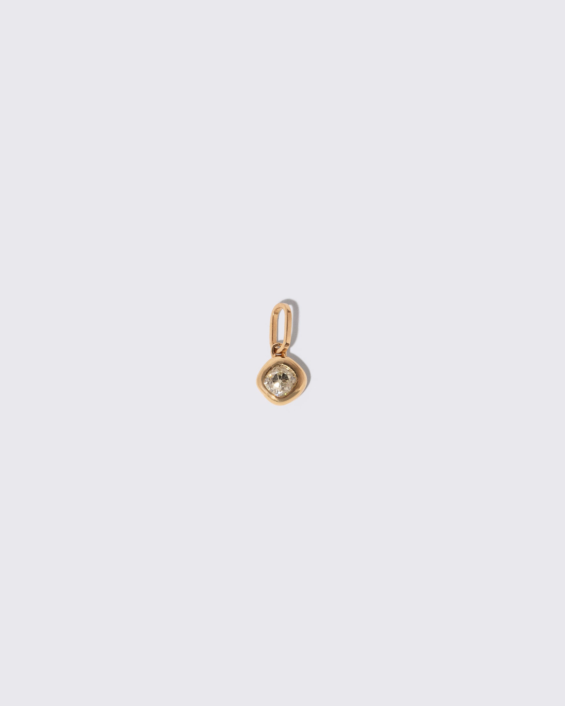 Diamond Poise Charm on light color background.