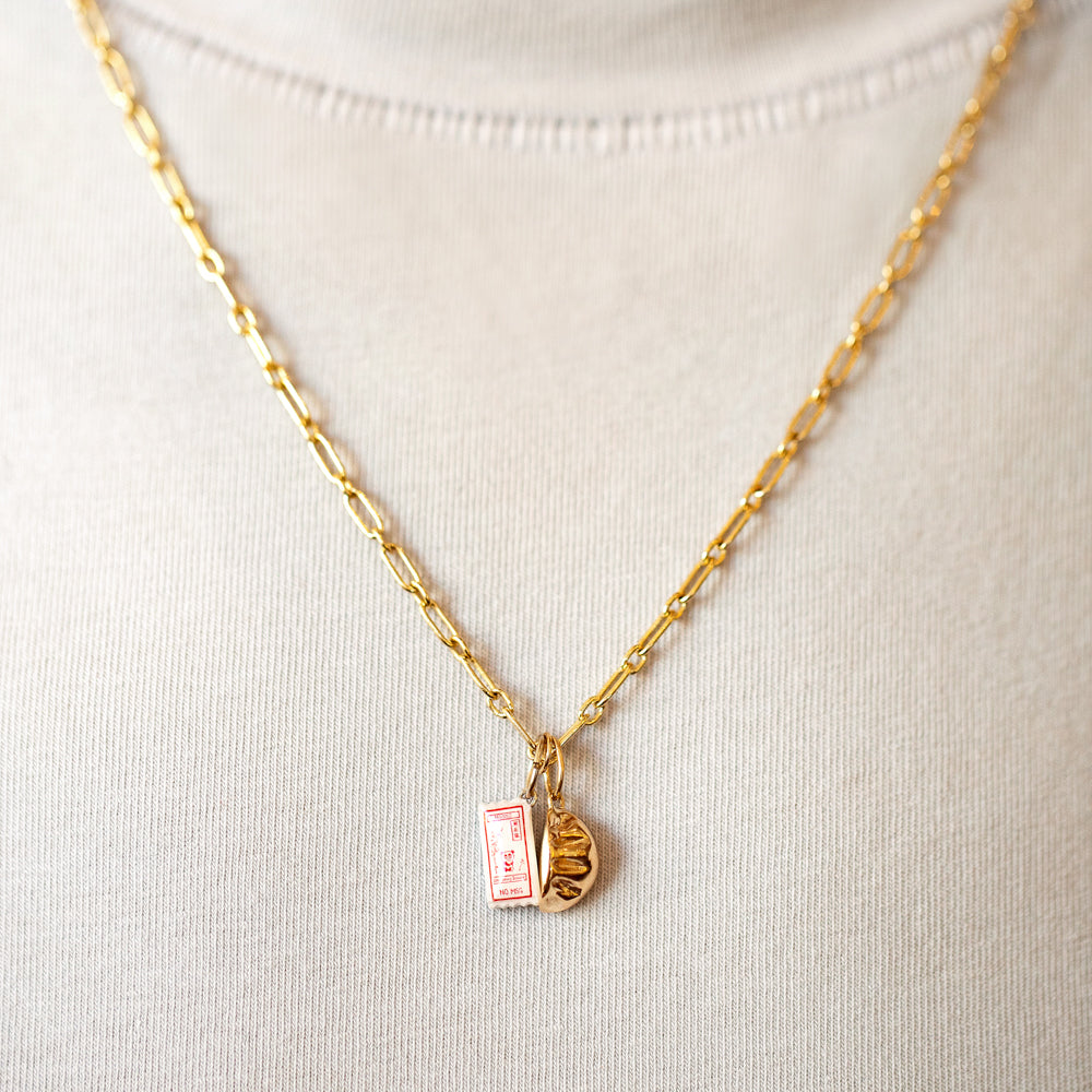 product_details::Hot Dog Chain Necklace, Dumpling Sauce Packet Charm and Steamed Dumpling Charm on model.