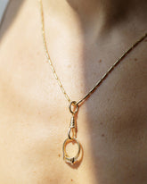 Gold Butter Chain Necklace worn with a Gold Oval Openable Link clipped to the Gold Grid Swivel Charm Holder protecting an engagement ring on model.