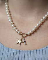 Gold Pearl Openable Link Necklace, Gold Large Verve Five Point Star Charm and Sapphire Identity Charm on model.