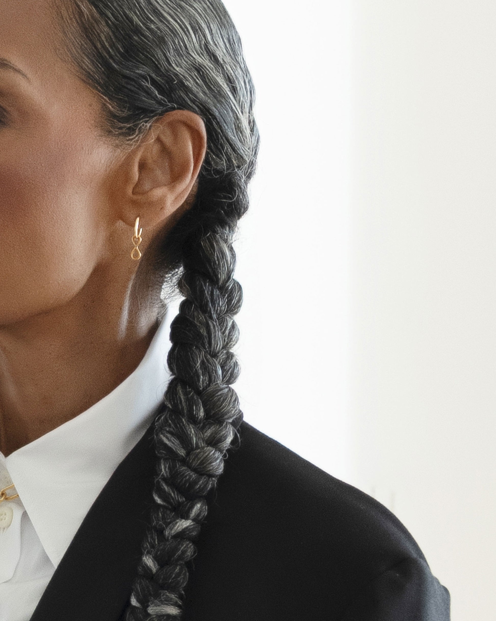 Styled image on model featuring the Infinity Styling Link on the Styling Huggie Hoop Earring Single.