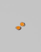 Halved Passion Fruit Charms on light color background.