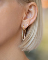 Huggie Gold Pavé Snack Hoop Earrings and Link Huggie Earring Single with Pavé Link Charm on model.