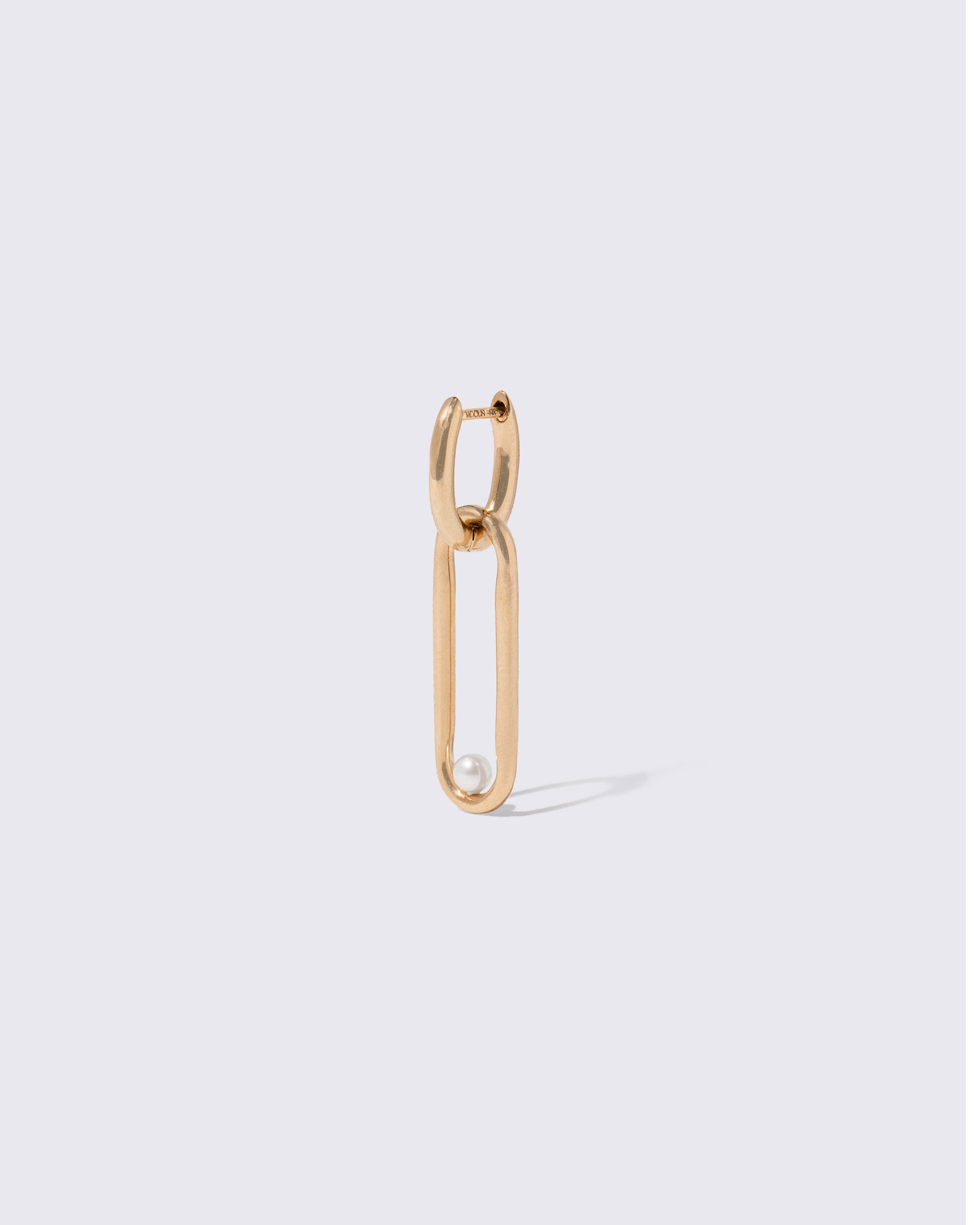 Closeup details of the Styling Huggie Hoop Earring Single and Pearl Styling Link on light color background. Earring sold separately.