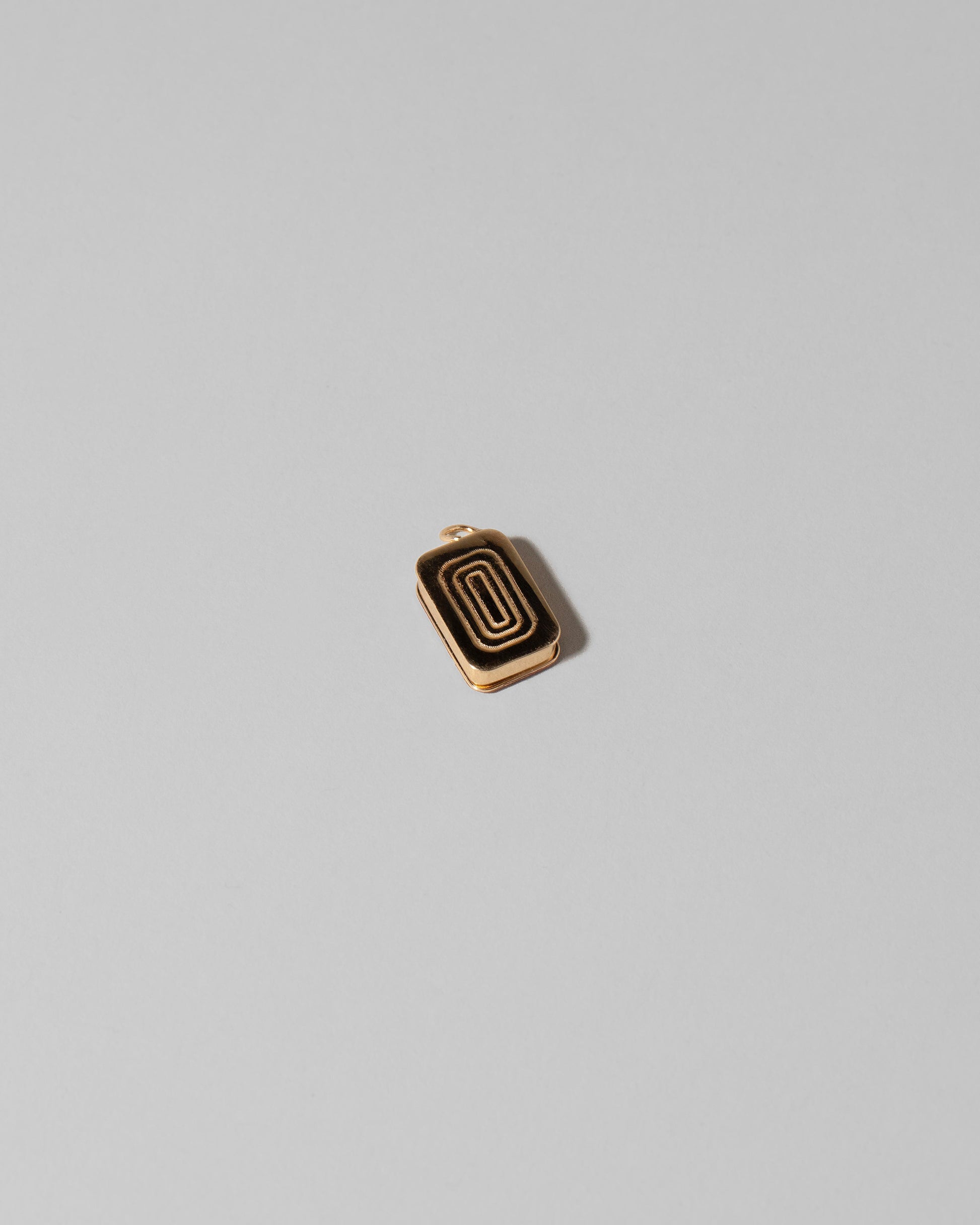 View from the back of the Sardine Can Charm on light color background.