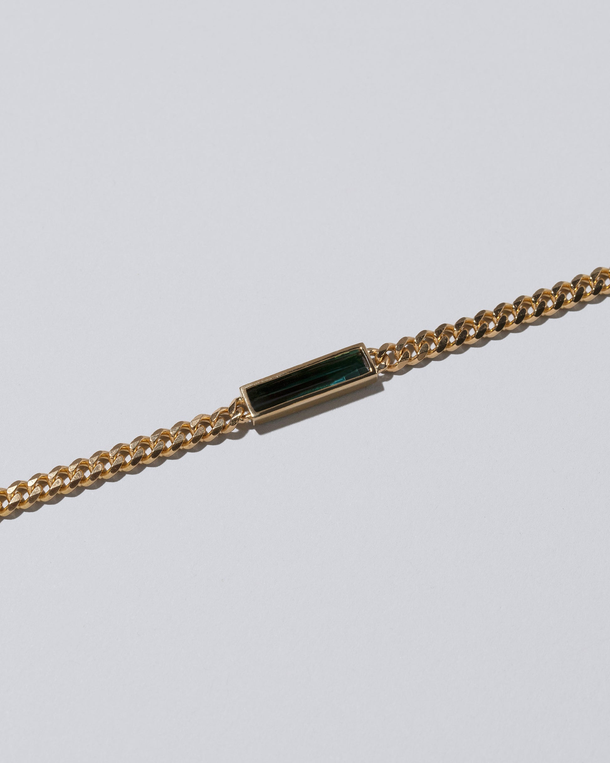 Closeup details of the Generosity Necklace on light color background.