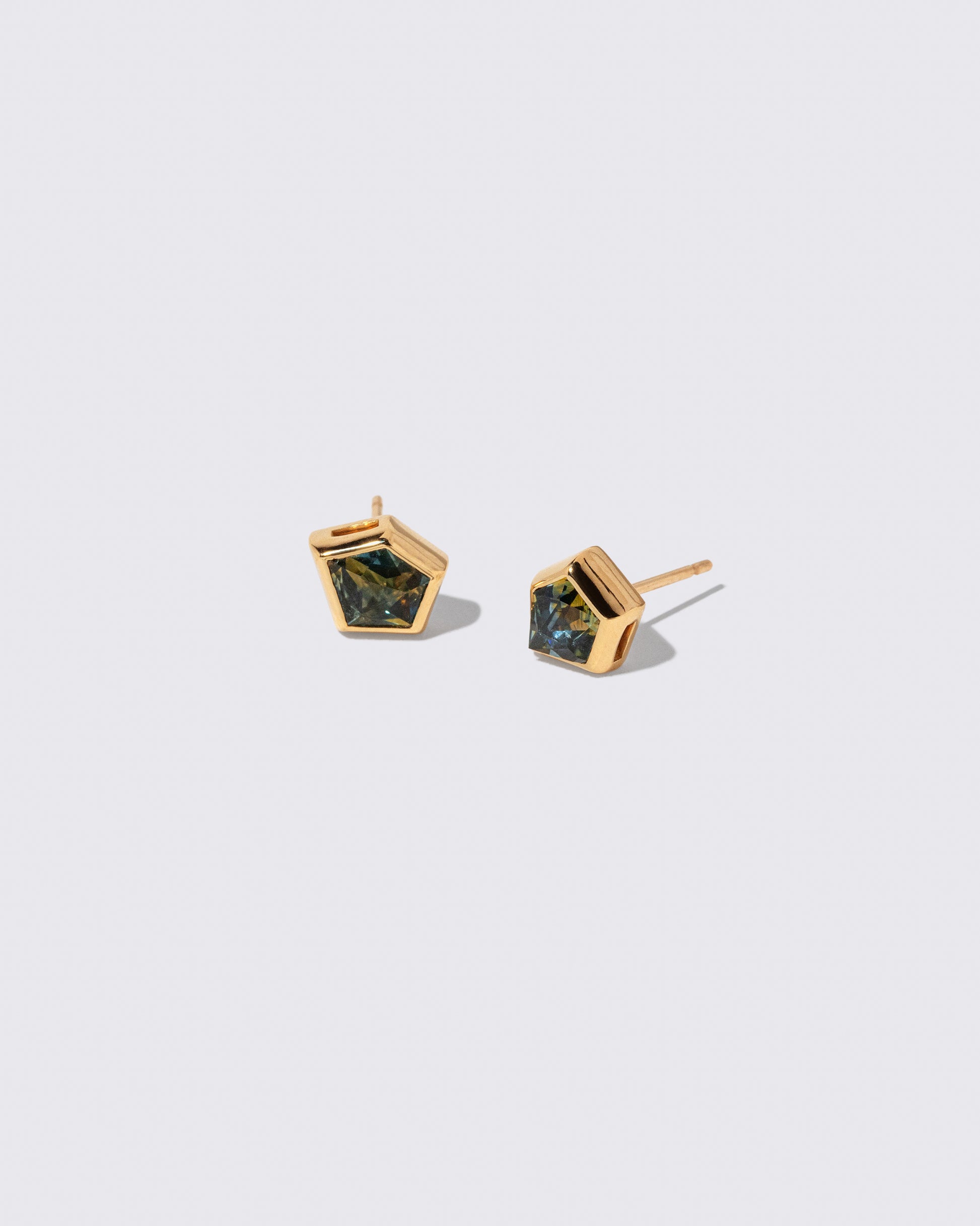 Teal Bicolor Sapphire Geyser Stud Earrings on light color background.