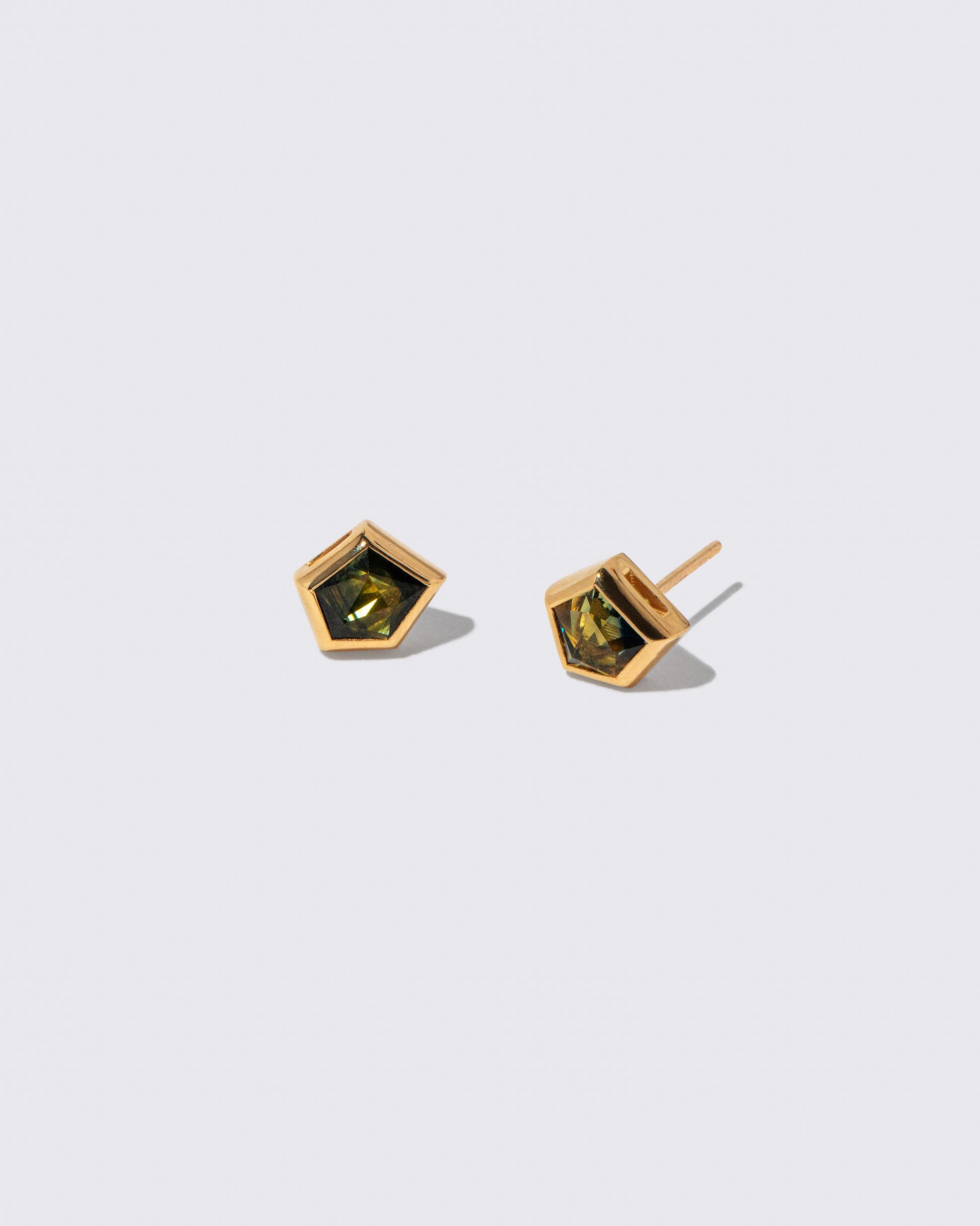 Green Bicolor Sapphire Geyser Stud Earrings on light color background.
