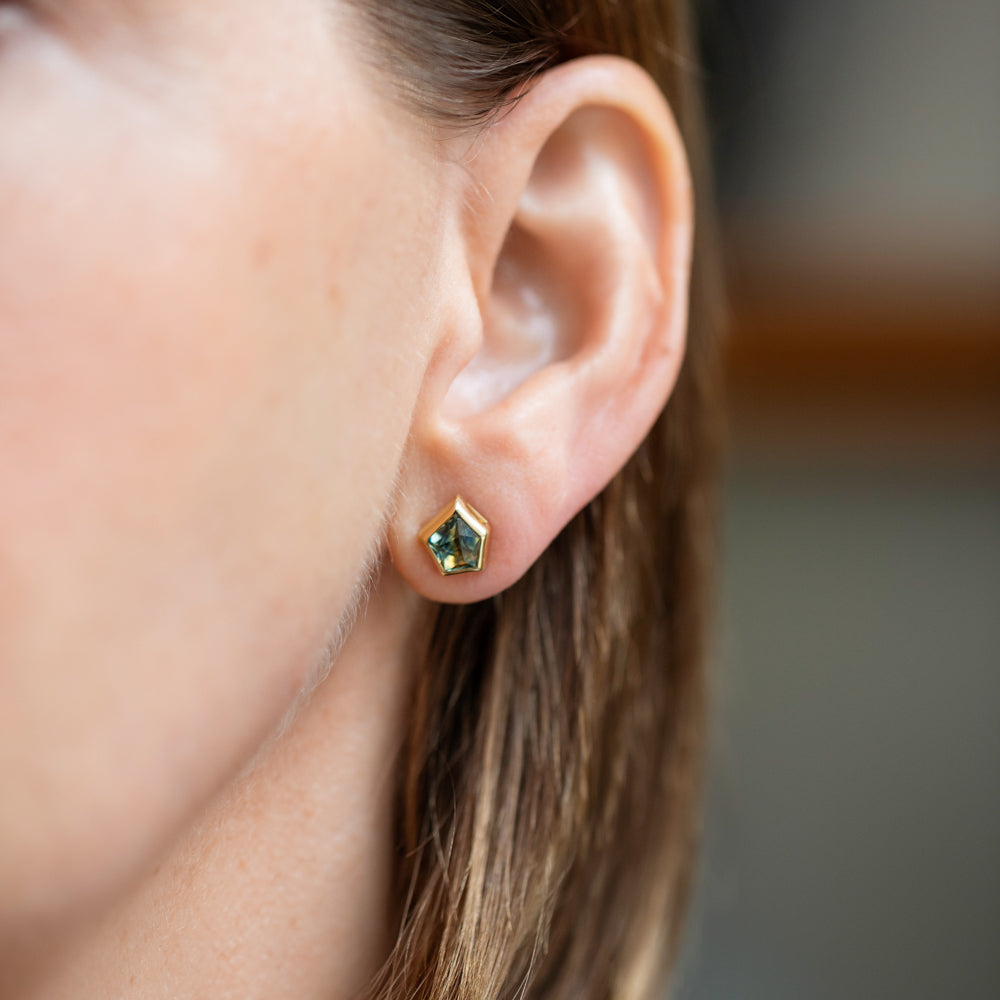 product_details::Teal Bicolor Sapphire Geyser Stud Earrings on model.