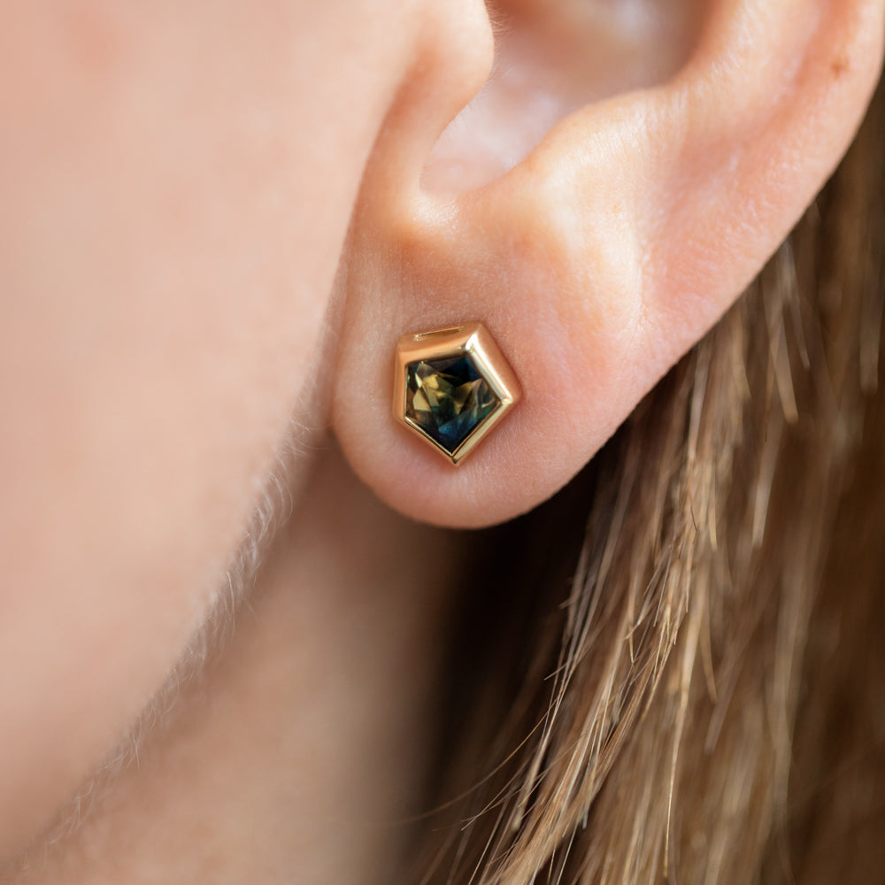product_details::Green Bicolor Sapphire Geyser Stud Earrings on model.
