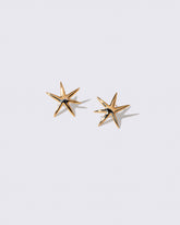 Gold Large Verve Six Point Star Stud Earrings on light color background.