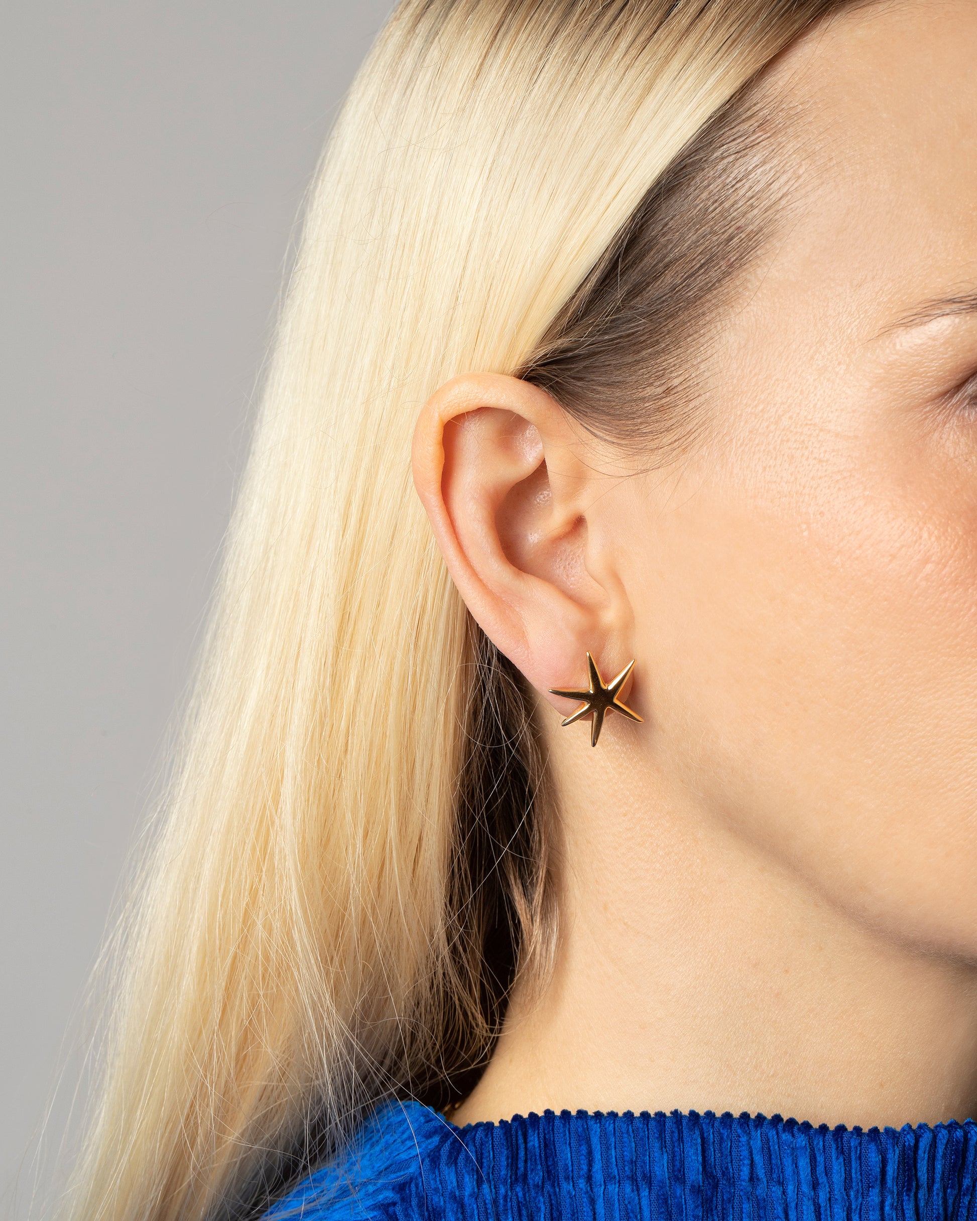 Gold Large Verve Six Point Star Stud Earrings on model.