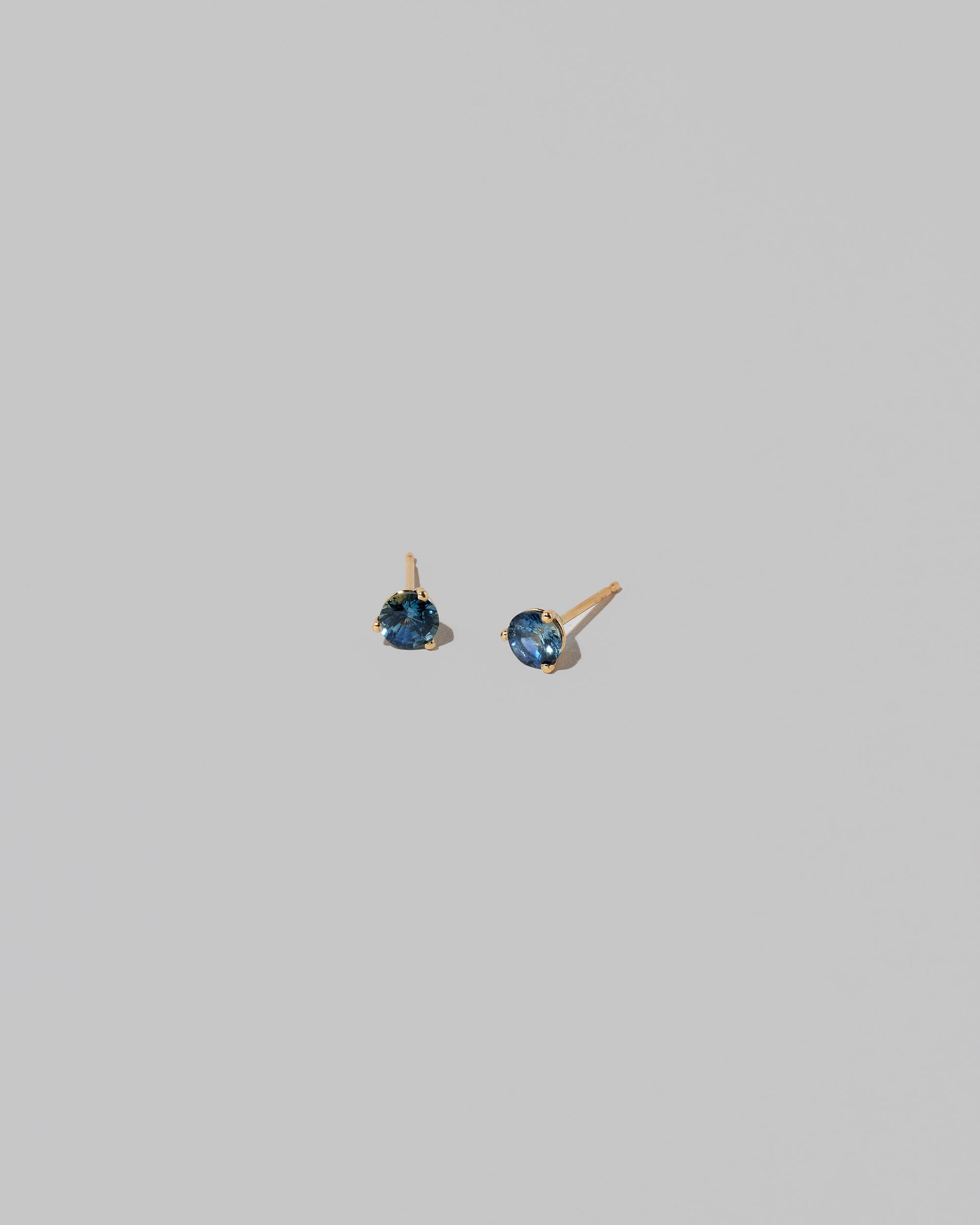 Grand Bicolor Yellow/Blue Sapphire Martini Stud Earrings on light color background.