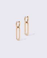 Pearl Link Huggie Hoop Earrings on light color background.