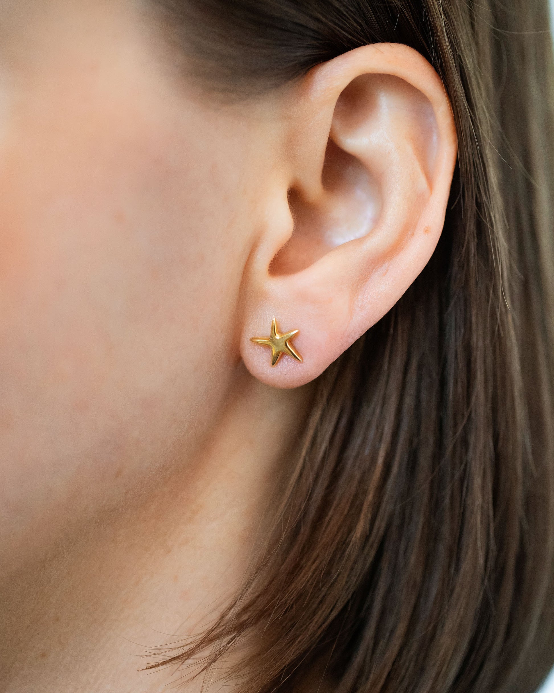Gold Verve Five Point Star Stud Earrings on model.