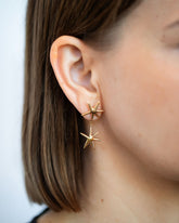 Gold Verve Star Drop Earrings on model.