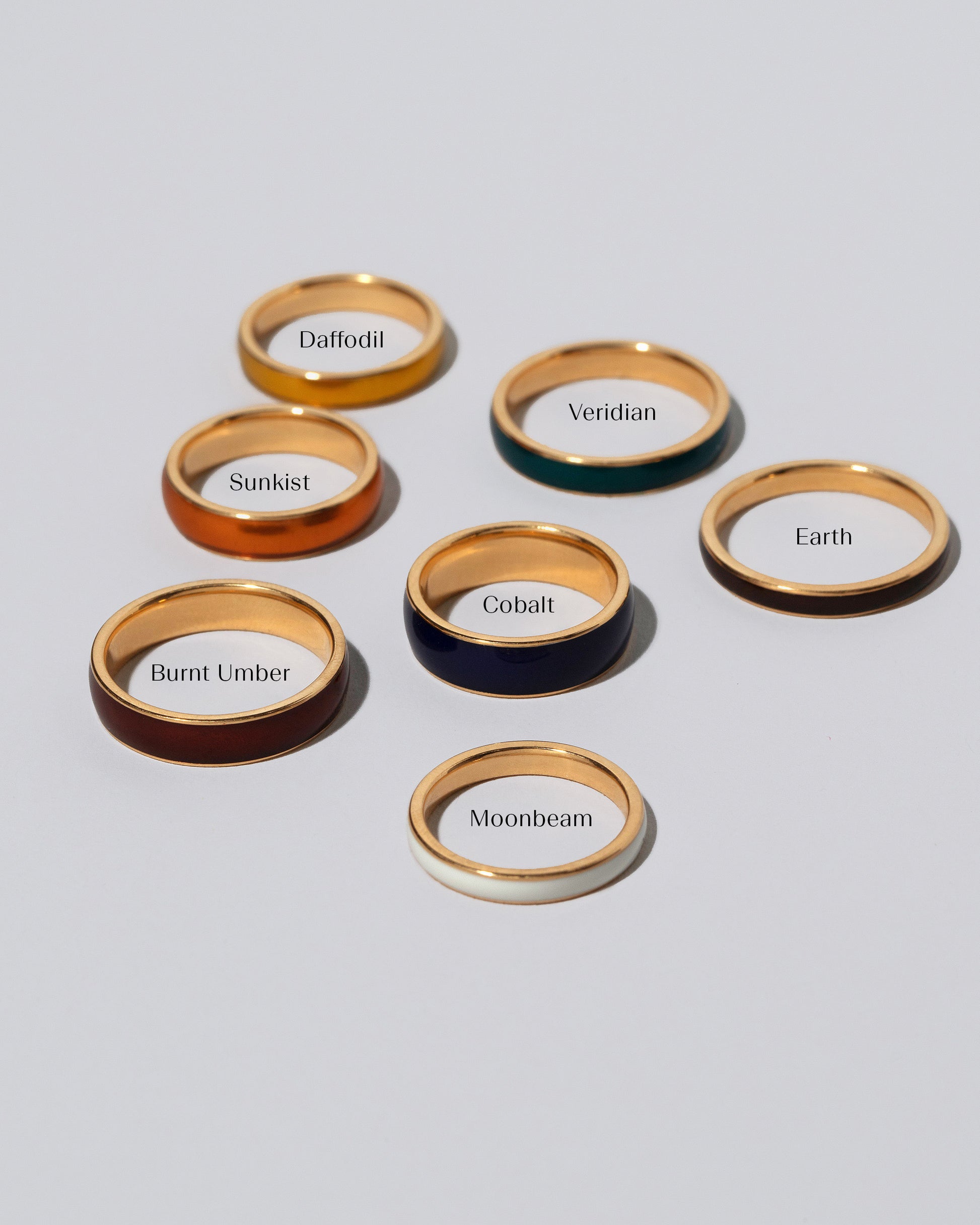 Photograph represents the 3mm size in Moonbeam (Glow in the Dark) and Earth (Deep brown); the 4mm size in Daffodil (Yellow) and Veridian (Deep Green), the 5mm size in Sunkist (Orange) and Burnt Umber (Deep Red), and in the 6mm size in Cobalt (Navy Blue) and Ink (Black).