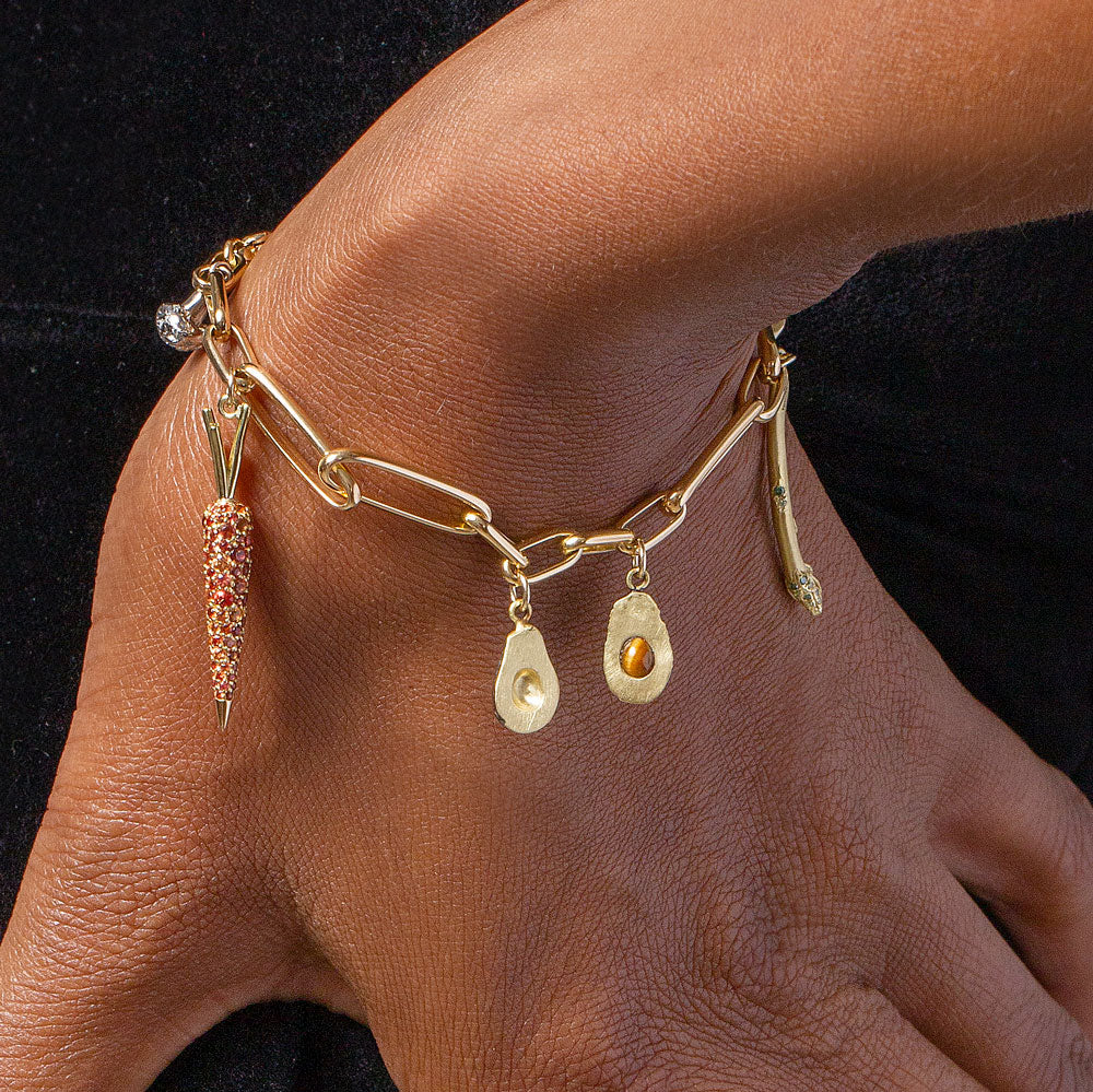 product_details::Loop Chain Bracelet with the Asparagus Charm, Halved Avocado Charms, Carrot Charm and Cauliflower Charm on model.