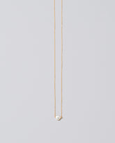 White Lagniappe Pearl Necklace on light color background.