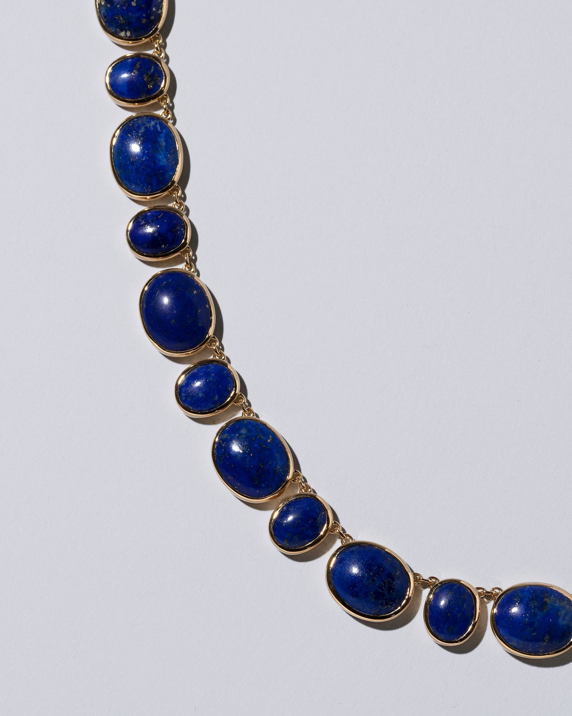 Closeup details of the Apparition Necklace on light color background.