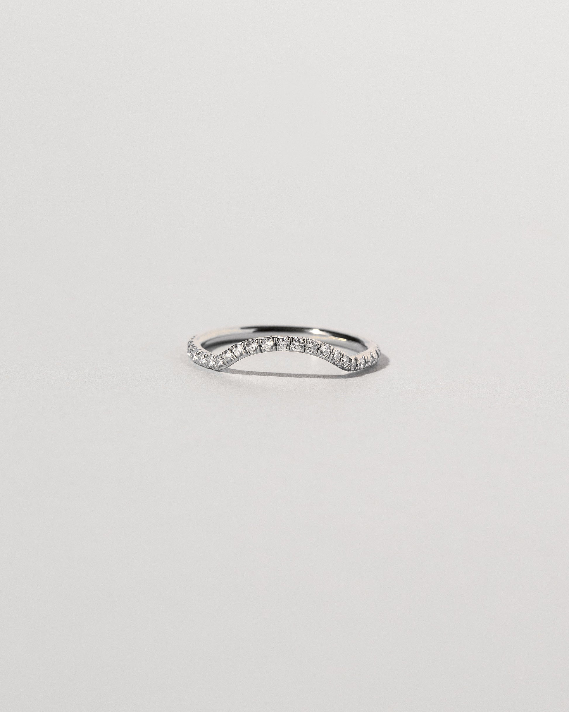 Platinum White Diamond Pavé Mini Curve Band on light color background.