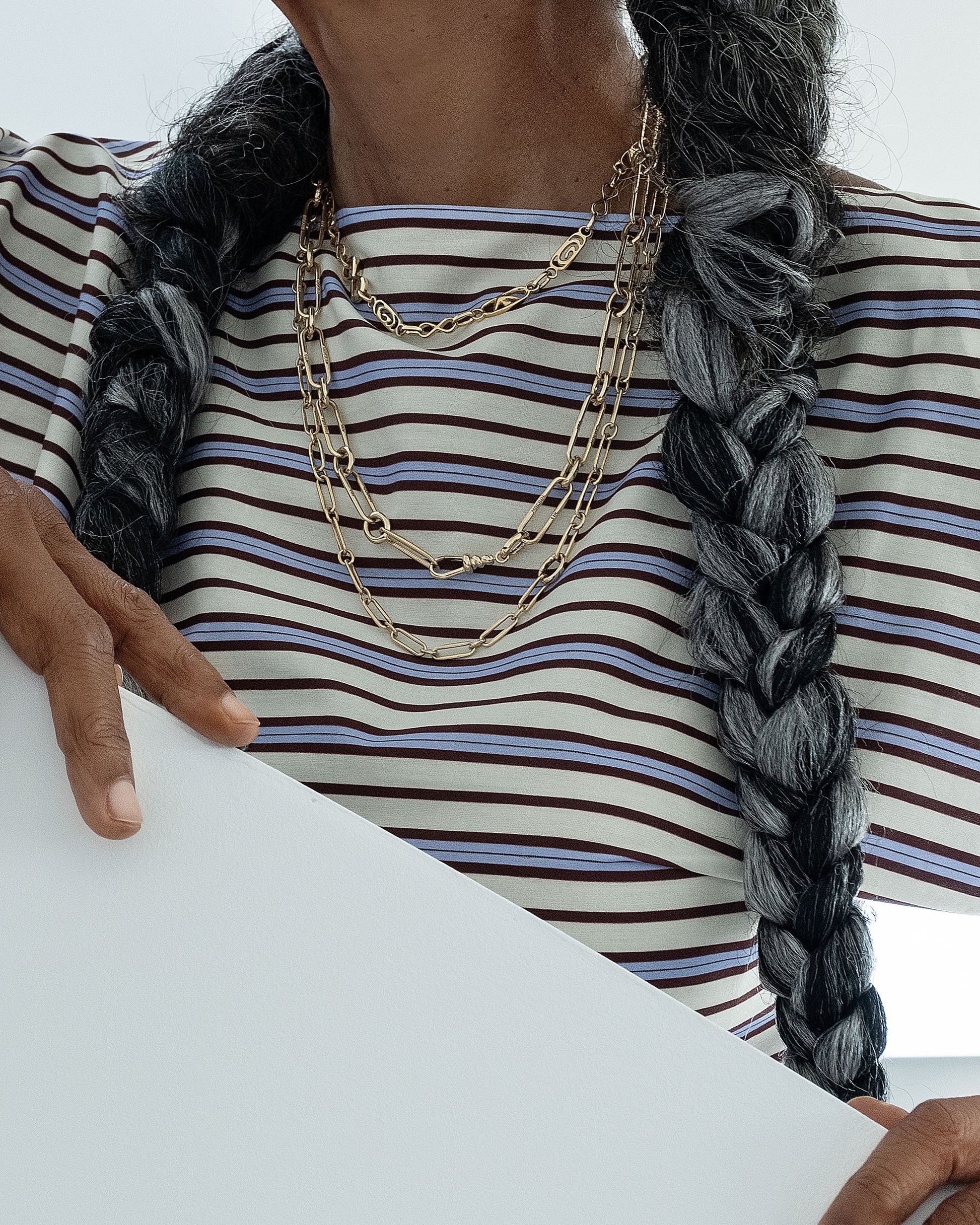 Styled image on model featuring the Infinity Openable Link Necklace, Link Necklace with its Coiled Swivel Charm Holder clasp centered, and a Petite Link Necklace.
