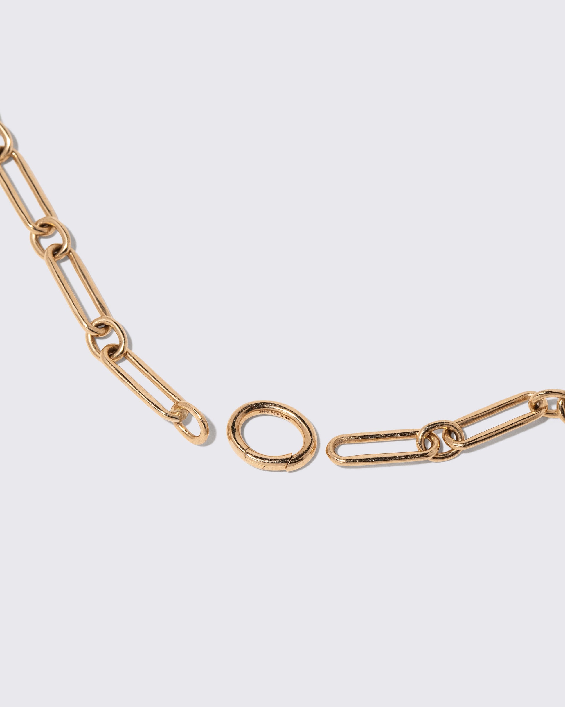 Detail view of the detachable Mociun Oval Openable Link closure on the Petite Link Necklace on light color background.