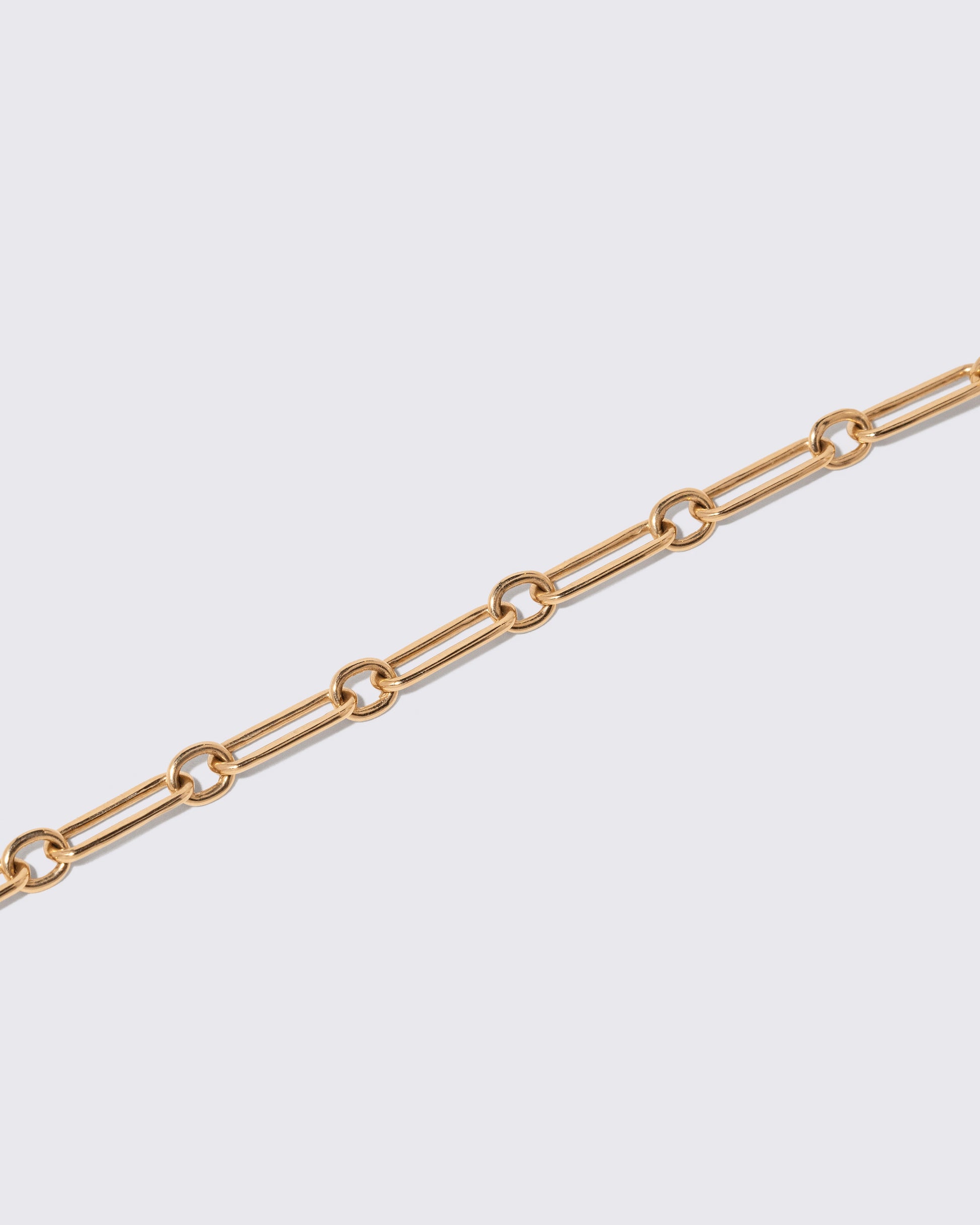 Closeup details of the Petite Link Necklace on light color background.