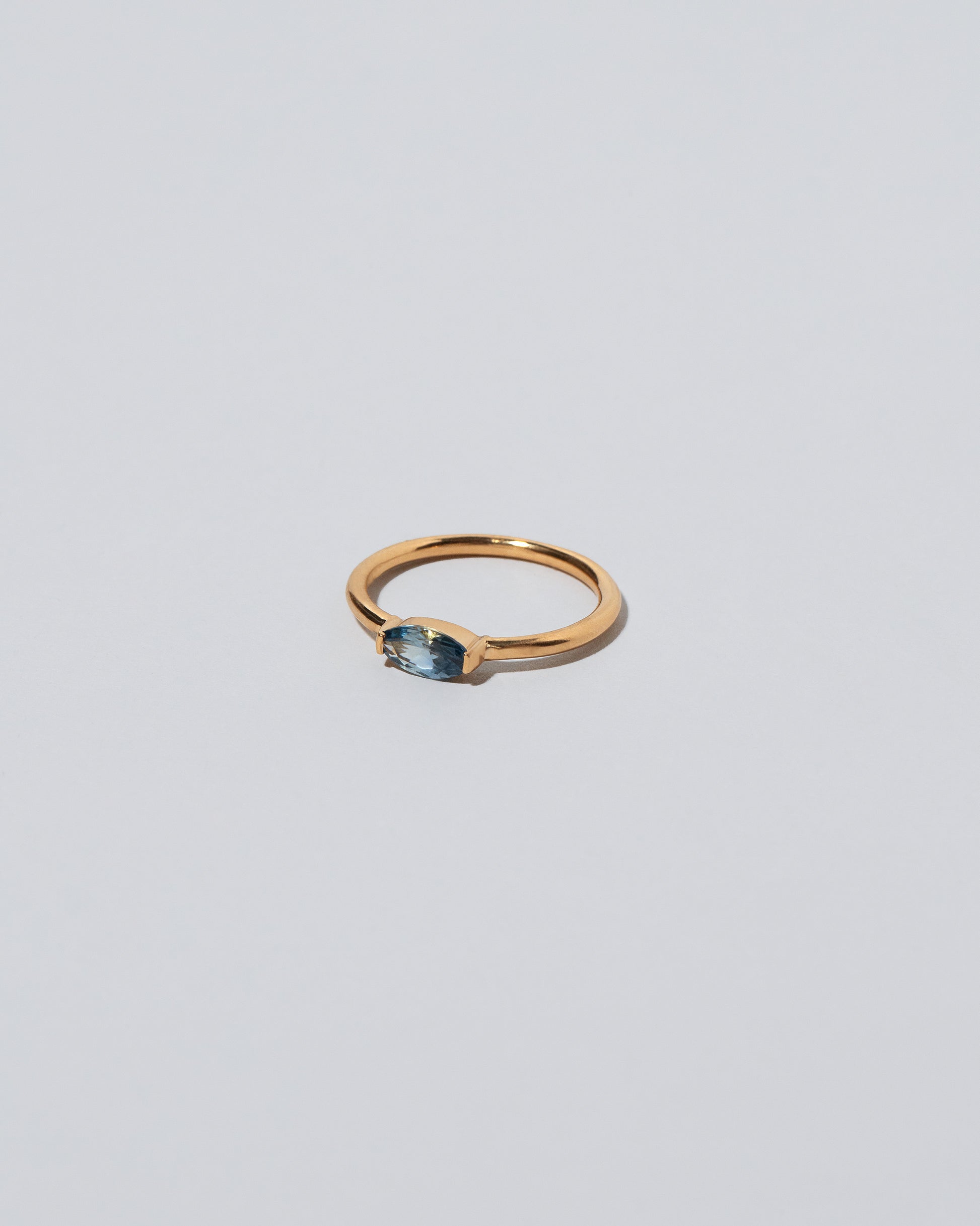 View from the side of the Blue Devant Ring on light color background.