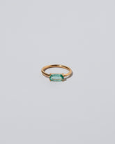 Green Adage Ring on light color background.
