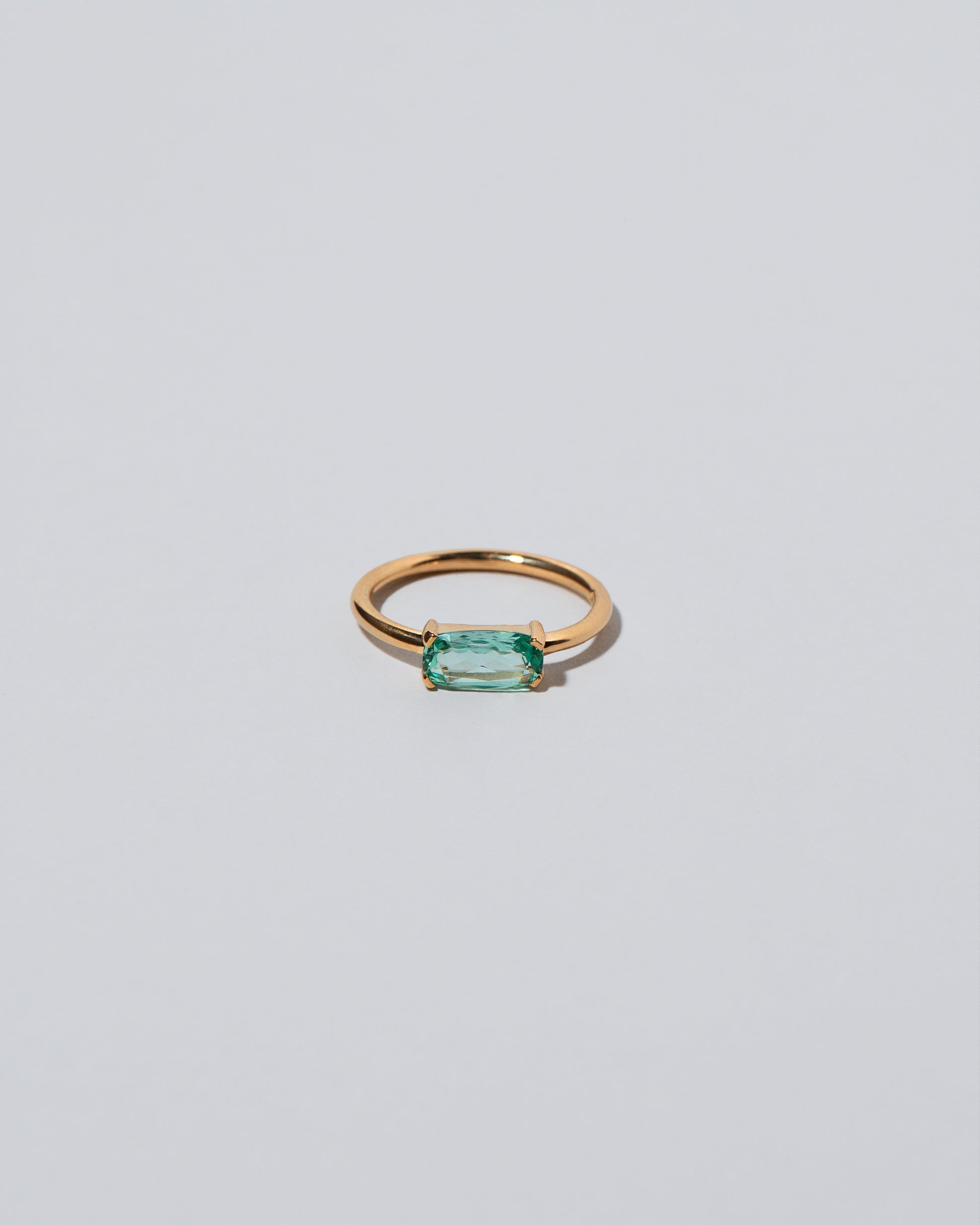 Green Adage Ring on light color background.