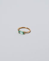 View from the side of the Green Adage Ring on light color background.
