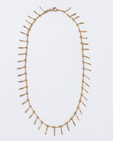 Petite Swaying Necklace on light color background.