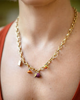 Stick of Salted Butter Charm, Passion Fruit Charms, California Poppy Charm, Daffodil Charm and Luna Ring Charm paired with Gold Endless Clasp Bracelets worn as a a necklace on model.