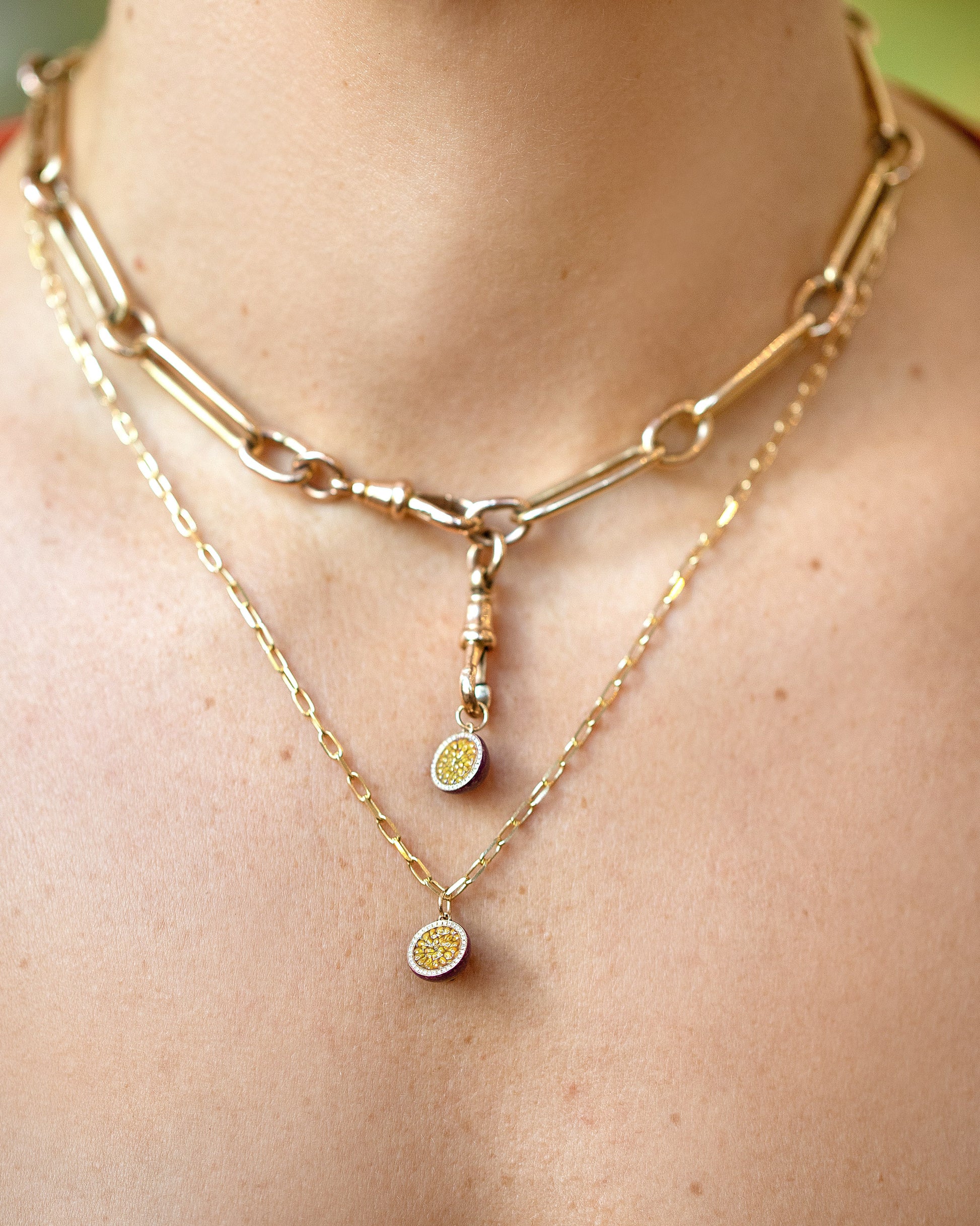 Halved Passion Fruit Charms paired with the Grand Swivel Fob and Solid Link Necklace layered with a Passion Fruit Charm paired with a 3.5mm Beveled Oval Chain Necklace on model.