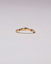Gold Five Stone Garnet High Peak Band on light color background.